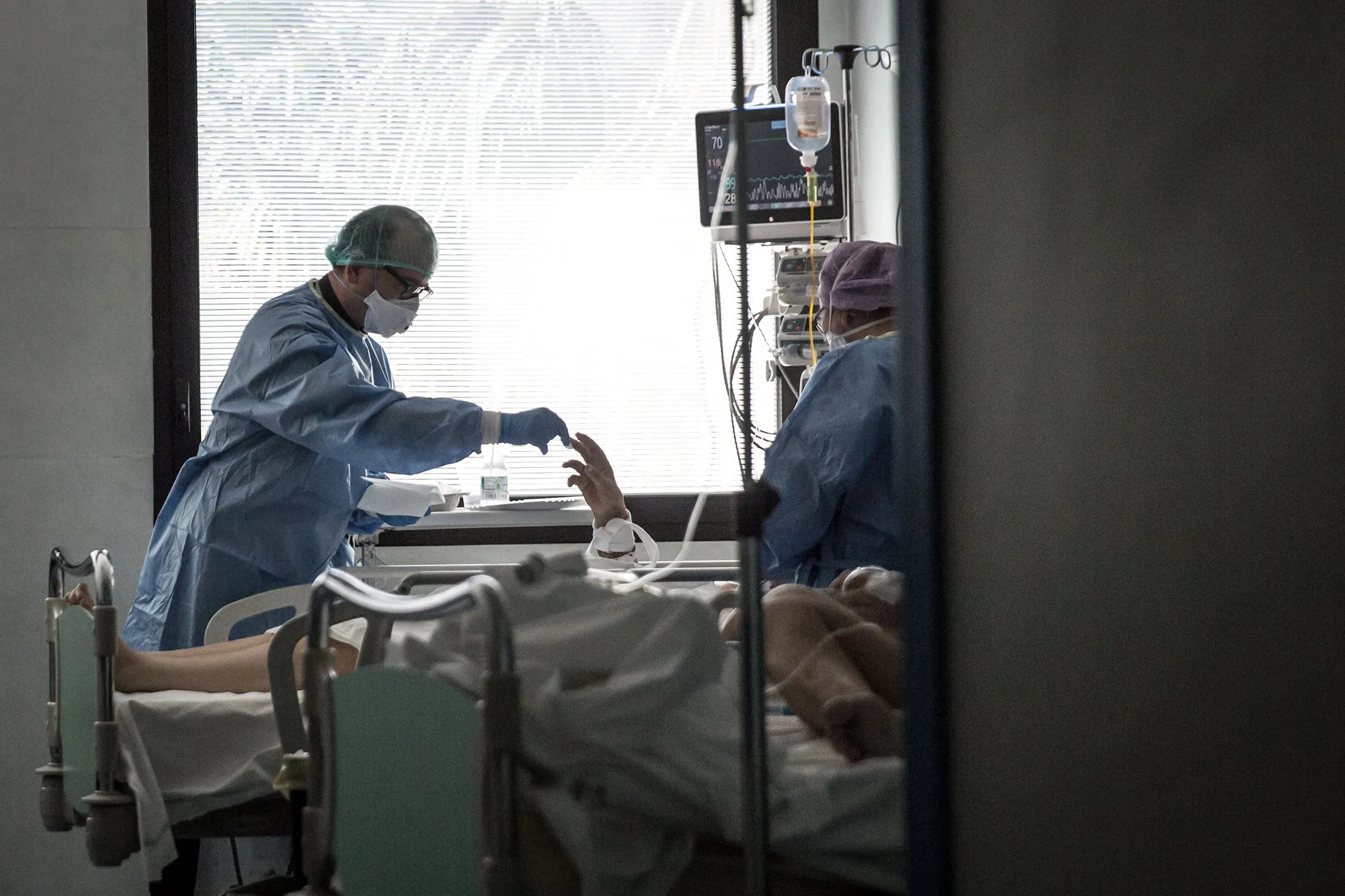 A priest in an Intensive Care Unit gives a blessing and holy communion to a patient&nbsp;during Easter in Sant'Orsola Hospital in Bologna on April 12.