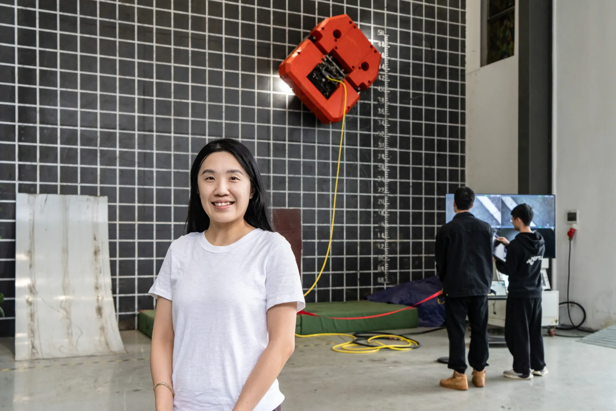 Elizabeth Chan with one of the company's robots at their R&D center in Shenzhen, China, in 2024.