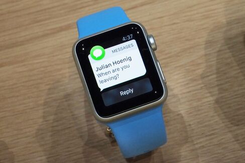 The aluminum Apple Watch Sport on a bright blue strap.