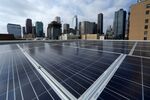 Solar panels on the roof of a building that offers individual solar-powered, net-zero-energy apartments in Los Angeles.