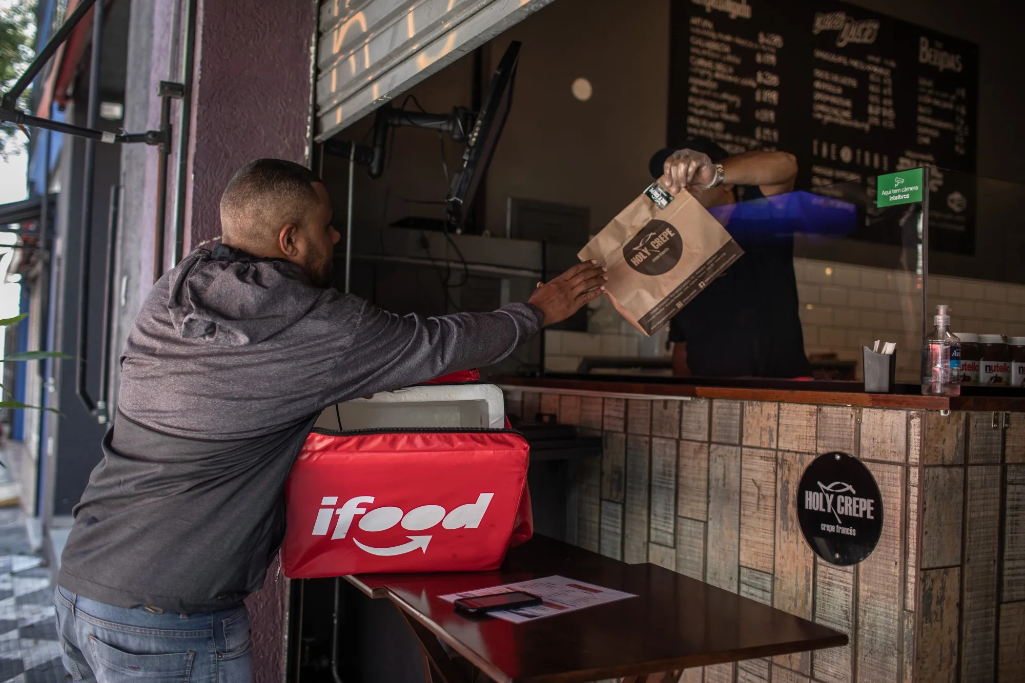 A worker picks up food&nbsp;to make an iFood app delivery in Sao Paulo.