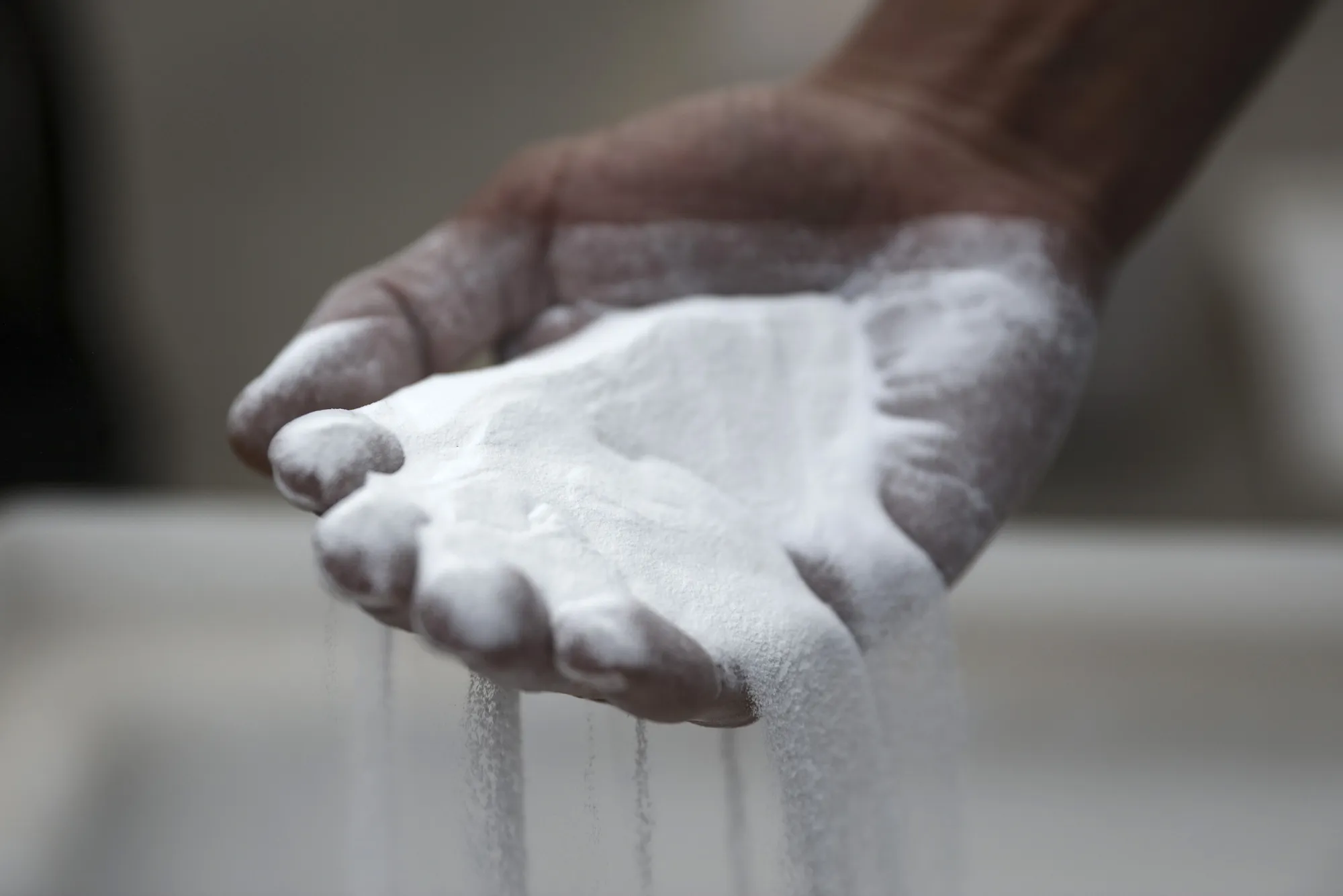 A&nbsp;worker holds processed alumina.