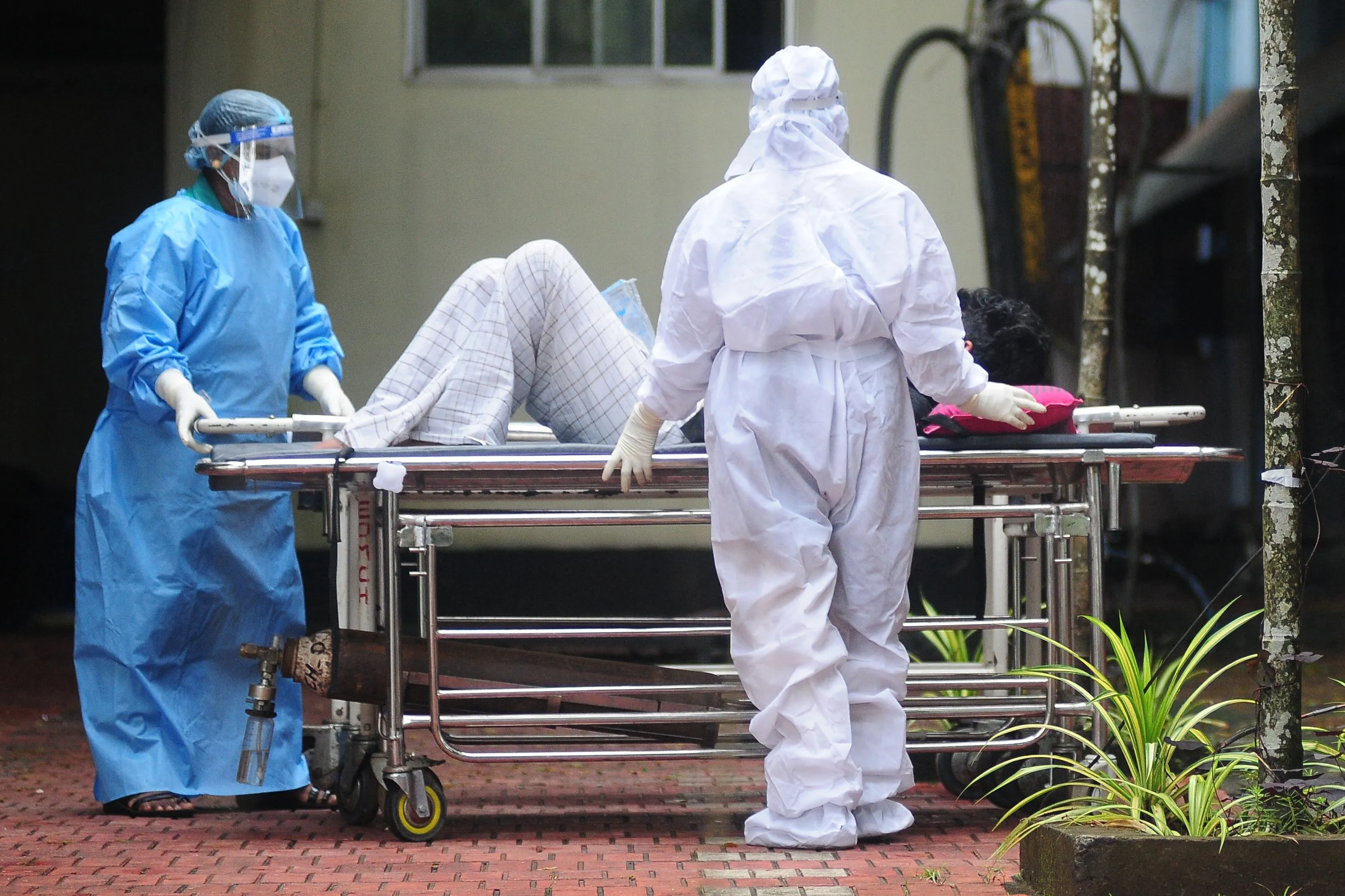 Health workers shift a man with symptoms of Nipah virus to an isolation ward at a hospital in Kerala in Sept. 2023.&nbsp;