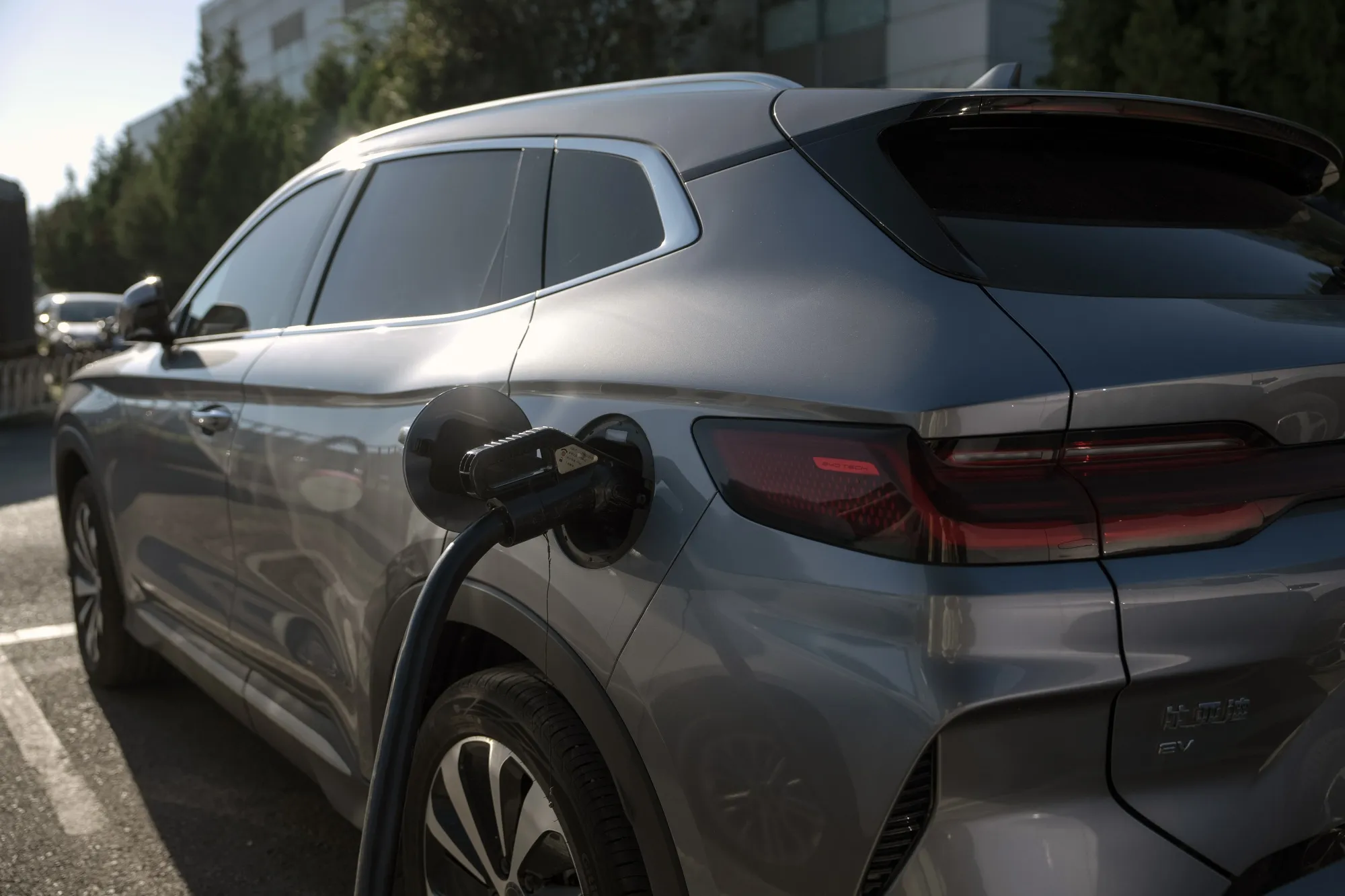 A BYD Co. electric vehicle charging outside one of the company's dealership in Beijing, China, on Tuesday, Aug. 27, 2024. China's top-selling automaker&nbsp;BYD expects overseas deliveries to account for almost half of total sales in the future, suggesting it will continue to set up global production hubs to overcome punishing tariffs.