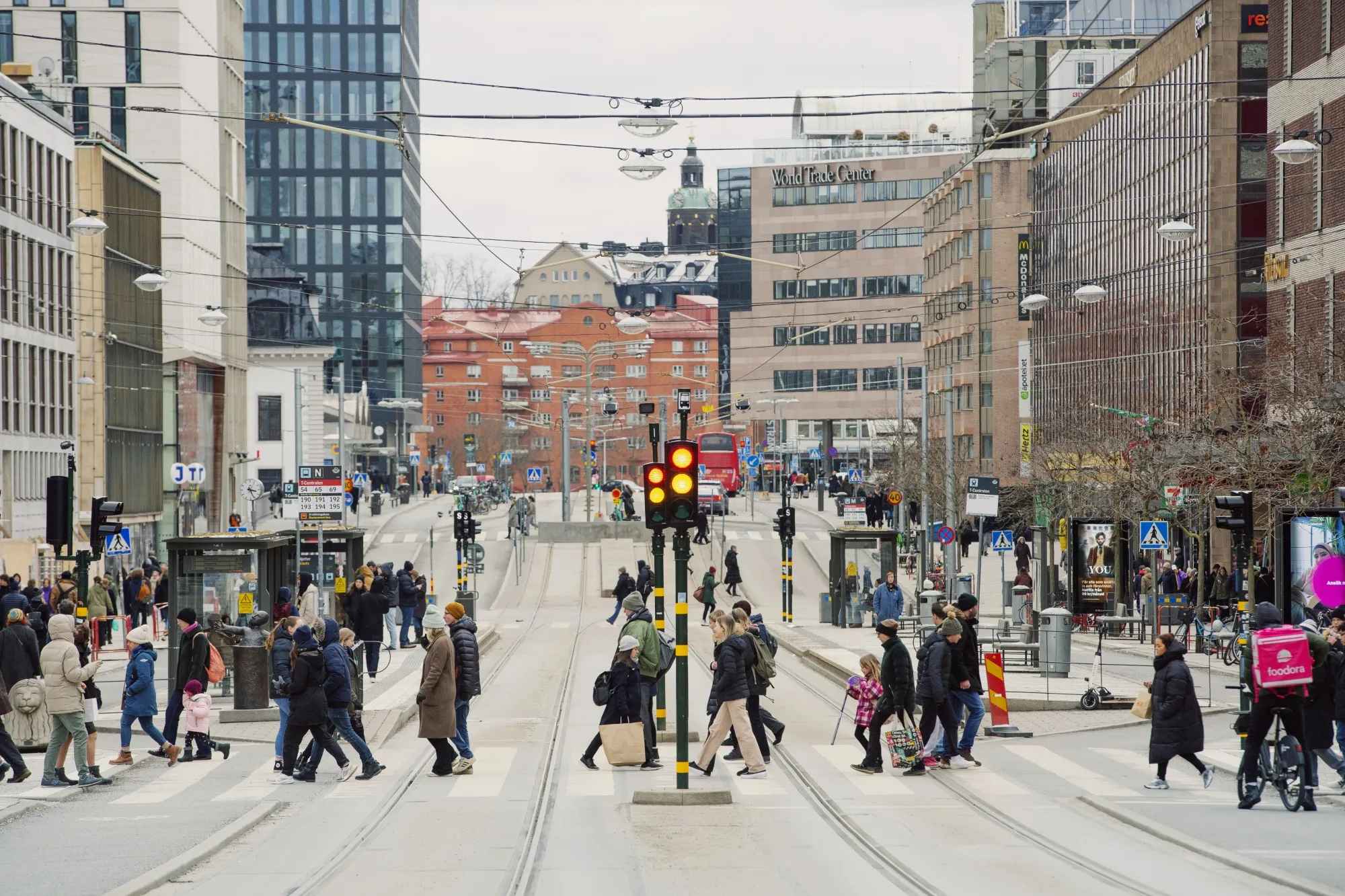 Shoppers cross Klarabergsgatan street in central Stockholm, Sweden.