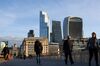 Commuters cross London Bridge in view of skyscrapers in the City of London skyline in London, U.K., on Thursday, Oct. 15, 2020. London is on course for an imminent tightening of coronavirus restrictions, as cases continue to rise in Britain and its response fragments.