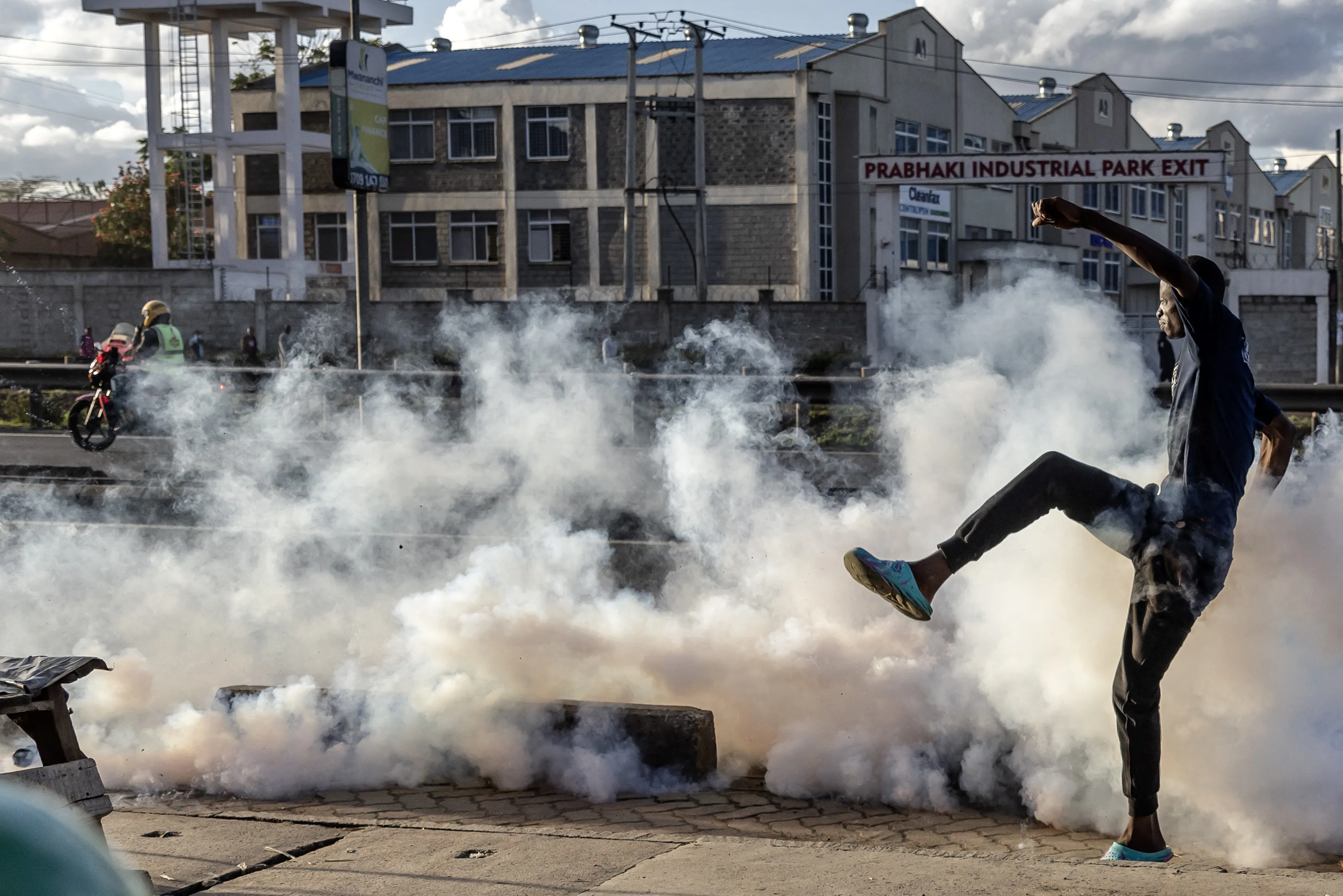 A protestor&nbsp;kicks a teargas canister&nbsp;during clashes at the informal settlement of Mathare in Nairobi on March 27.