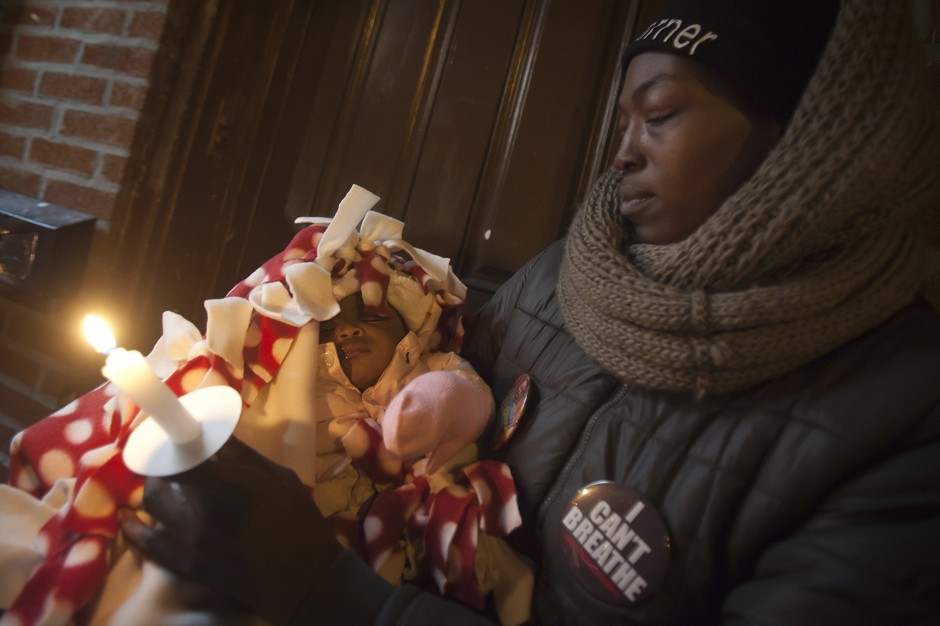 A woman attends a candlelight vigil for Eric Garner on Martin Luther King Day.
