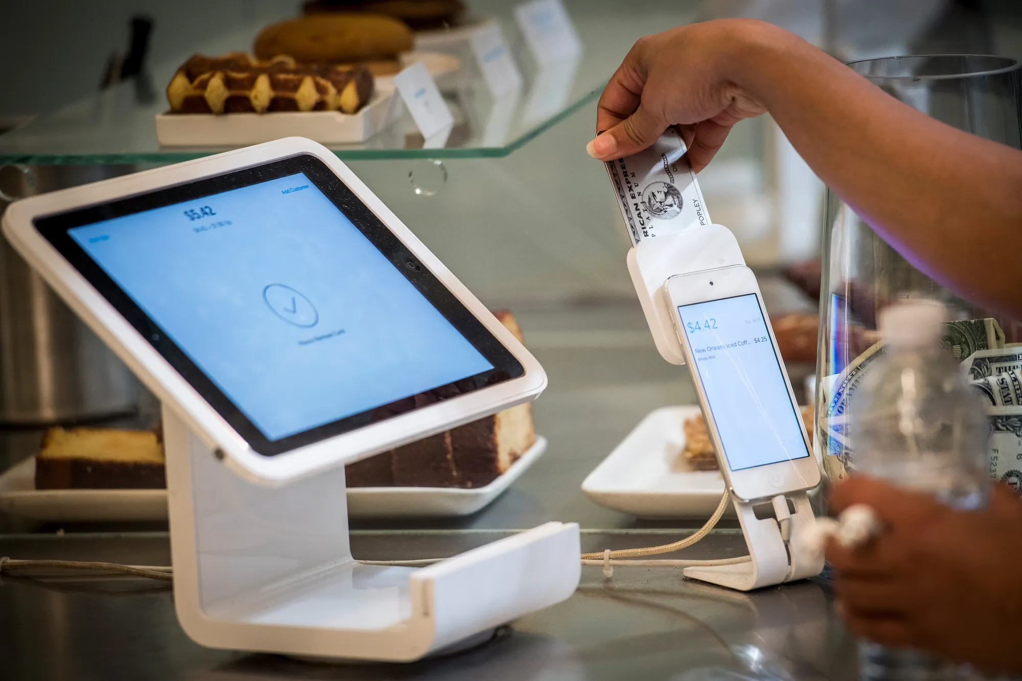 A customer removes a credit card into Square&nbsp;device while making a payment in San Francisco.
