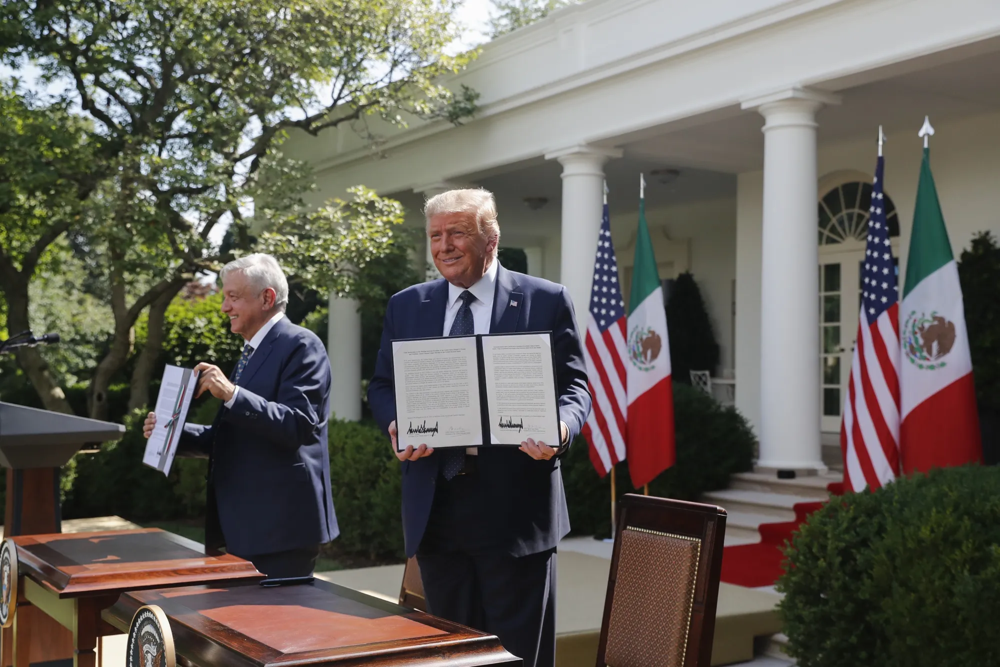 Donald Trump, right, and Andres Manuel Lopez Obrador, hold up joint declarations after being signed during a ceremony in the Rose Garden of the White House in Washington, D.C., U.S., on July 8.