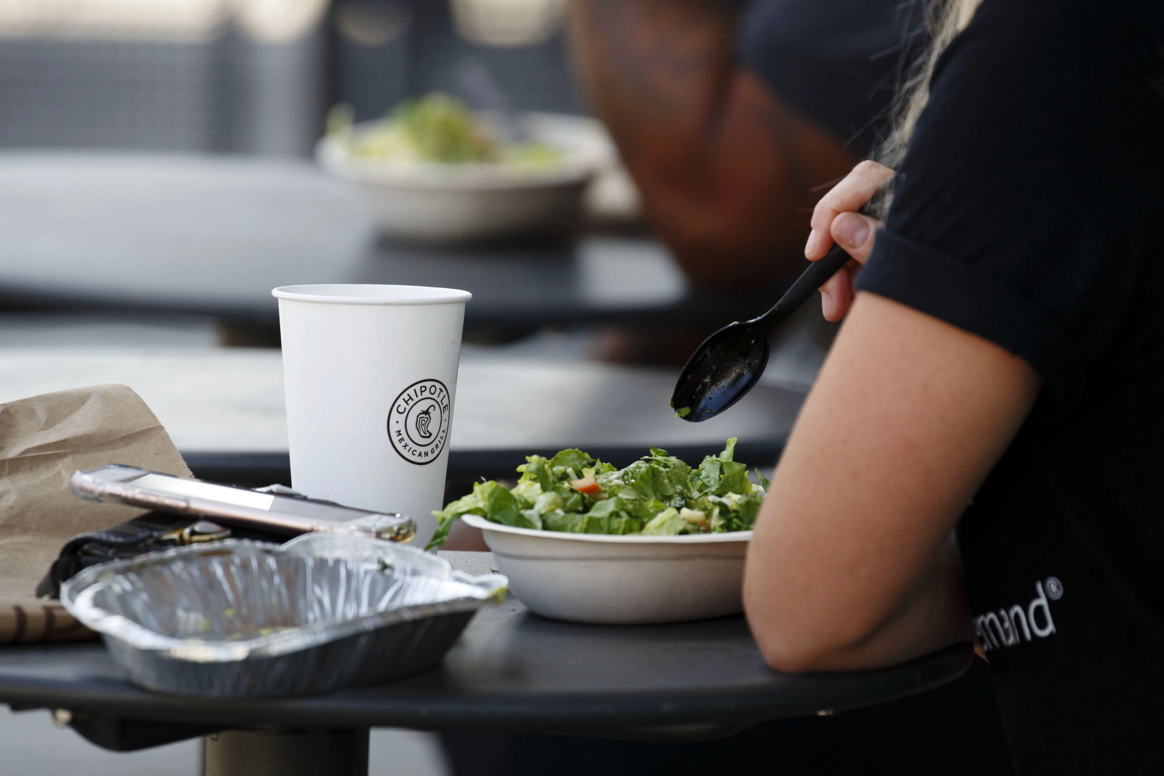 A customer eats a salad bowl at a Chipotle Mexican Grill Inc. restaurant.