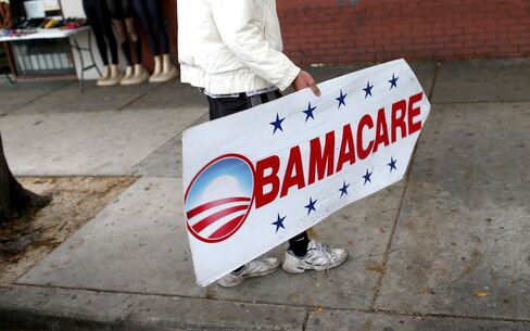 A sign directs people to an insurance company where they can sign up for the Affordable Care Act, also known as Obamacare, on Feb. 5, 2015, in Miami.