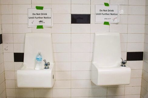 Signs above fountains warn against drinking the water at a school in Flint.