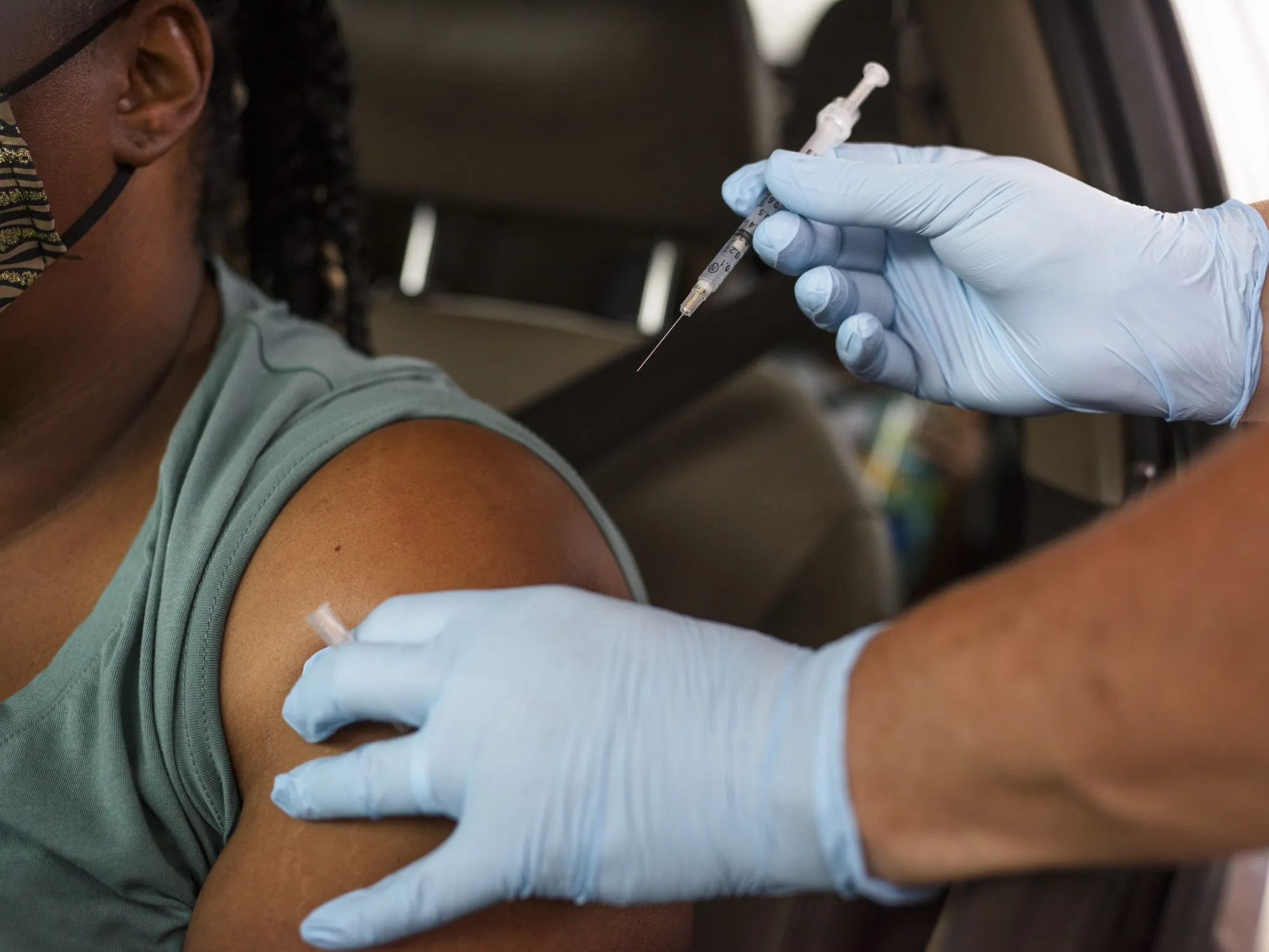 A healthcare worker administers a Covid-19 vaccine at the Austin Regional Clinic drive-thru vaccination and testing site in Austin, Texas, U.S., on Thursday, Aug. 5, 2021.&nbsp;