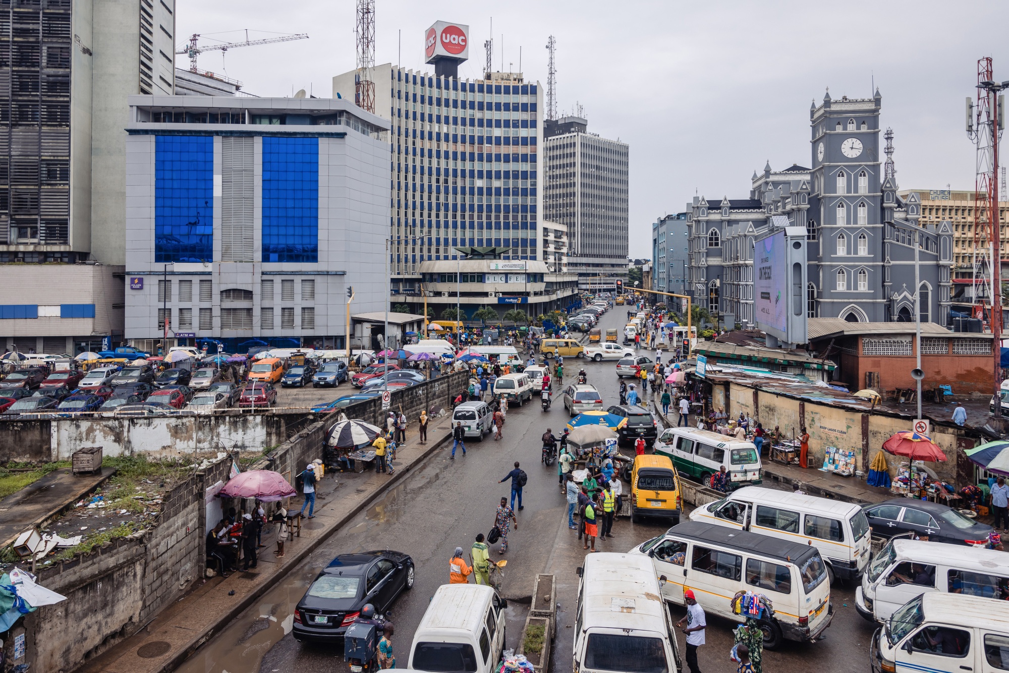 Taxi vans and street traders line a road in the Central Business District (CBD) of Lagos, Nigeria, on Monday, Aug. 14, 2023. Nigerian President Bola Tinubu has declared a state of emergency to counter the rising cost of living and in early August announced a 500 billion naira package of measures to improve food supply, ease transportation costs and boost manufacturing.
