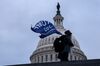 A demonstrator carries a "Trump 2020" flag outside the U.S. Capitol on Jan. 6.