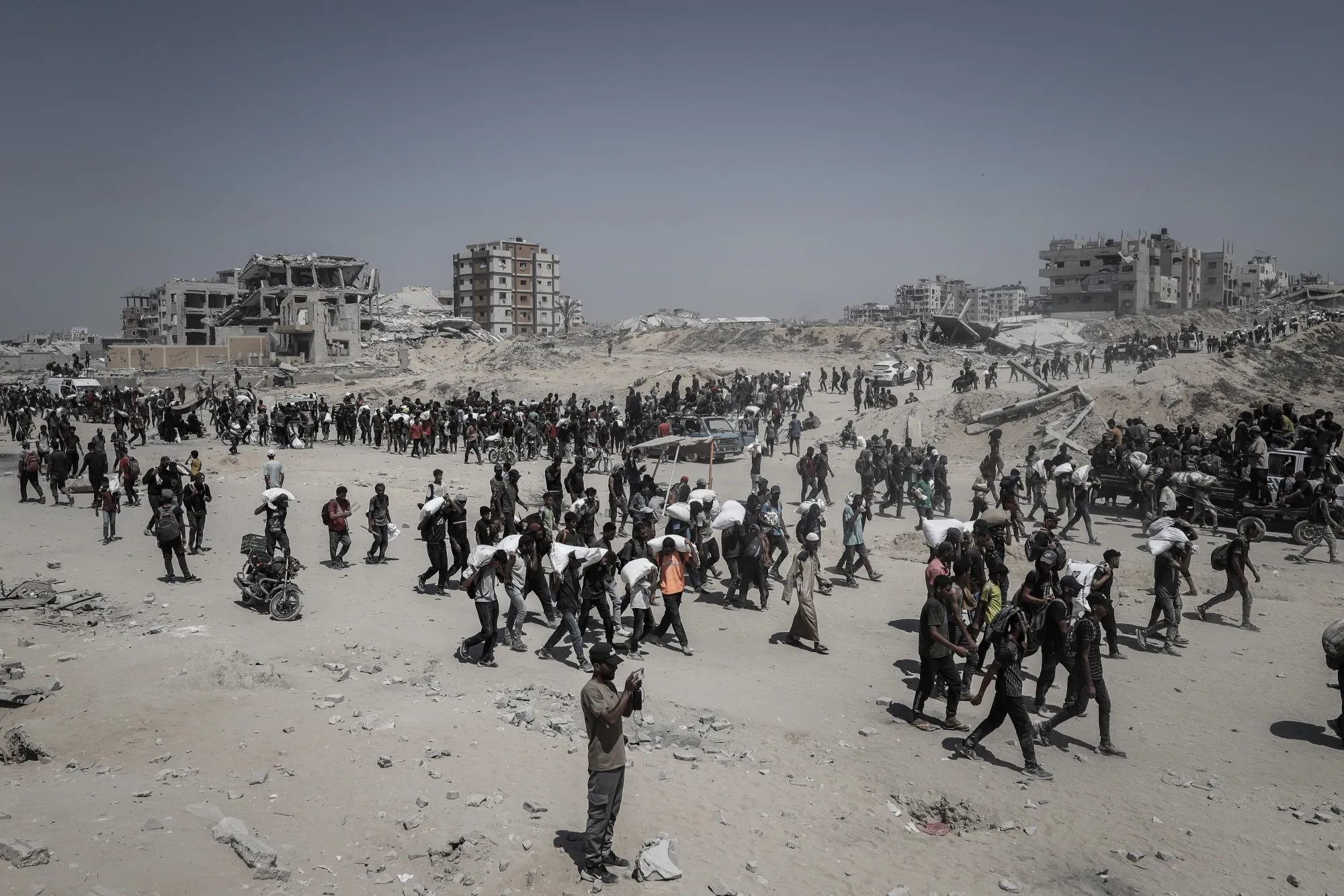 Palestinians carry aid supplies in northern Gaza in July.