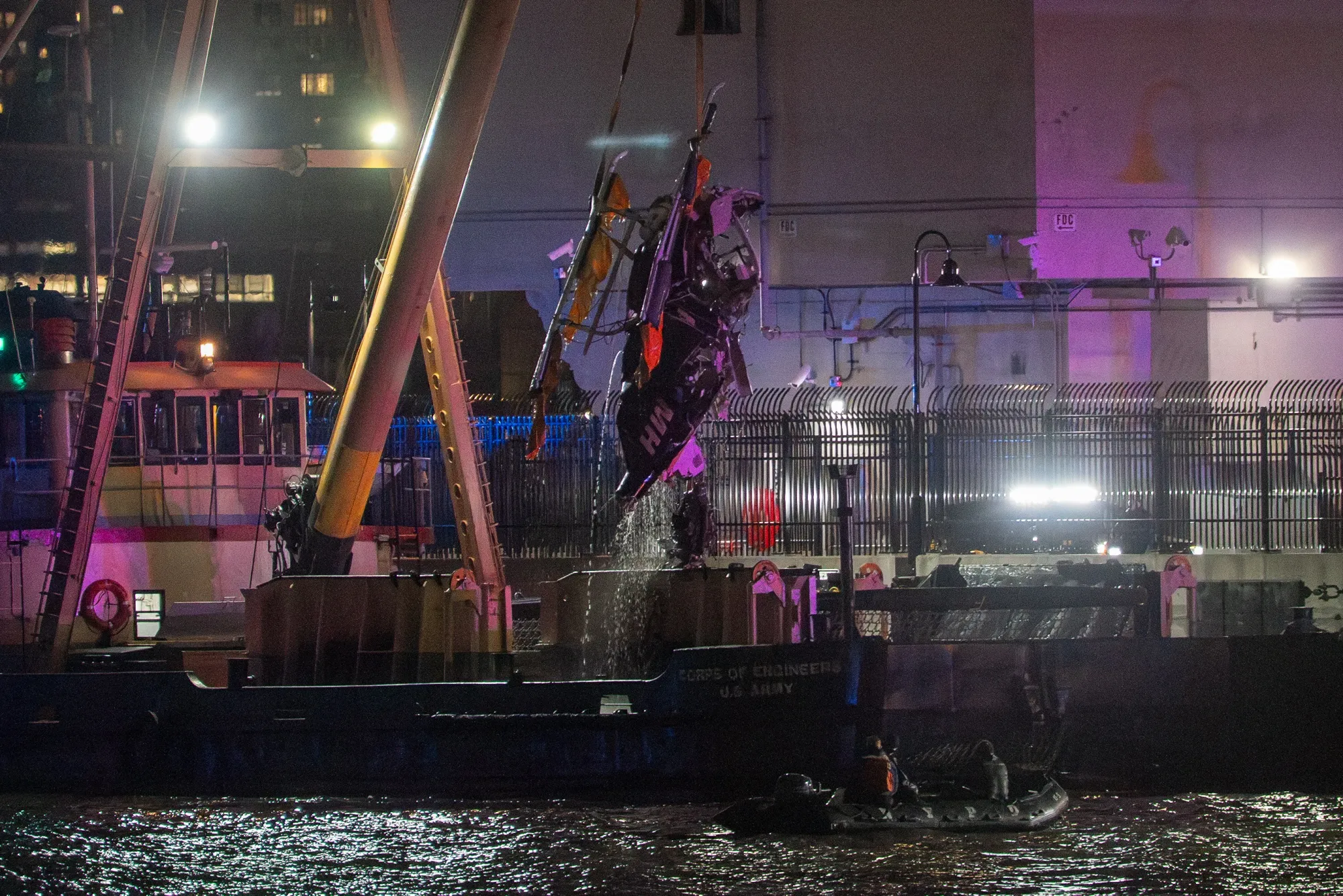 The wreckage of a helicopter that crashed into the Hudson River is extracted from the water in Jersey City on April 10.