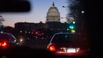 Scaffolding surrounds the U.S. Capitol Building Dome before sunrise, as seen from a taxi, in Washington, D.C., U.S., on Wednesday, Dec. 10, 2014.
