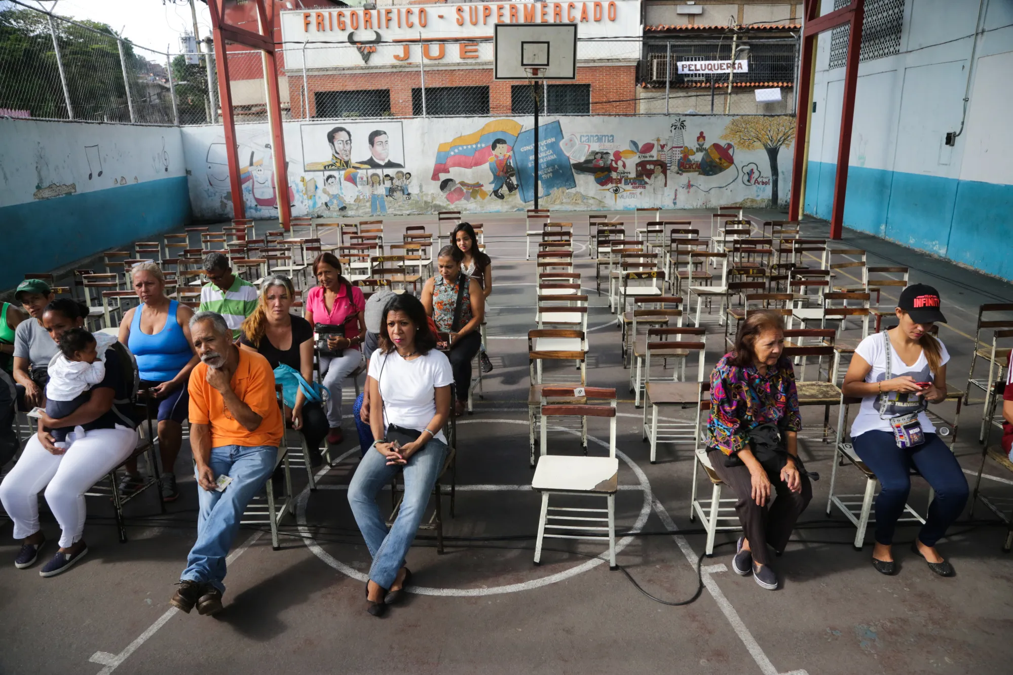Voters wait to cast ballots outside of a polling station during presidential elections in Caracas.