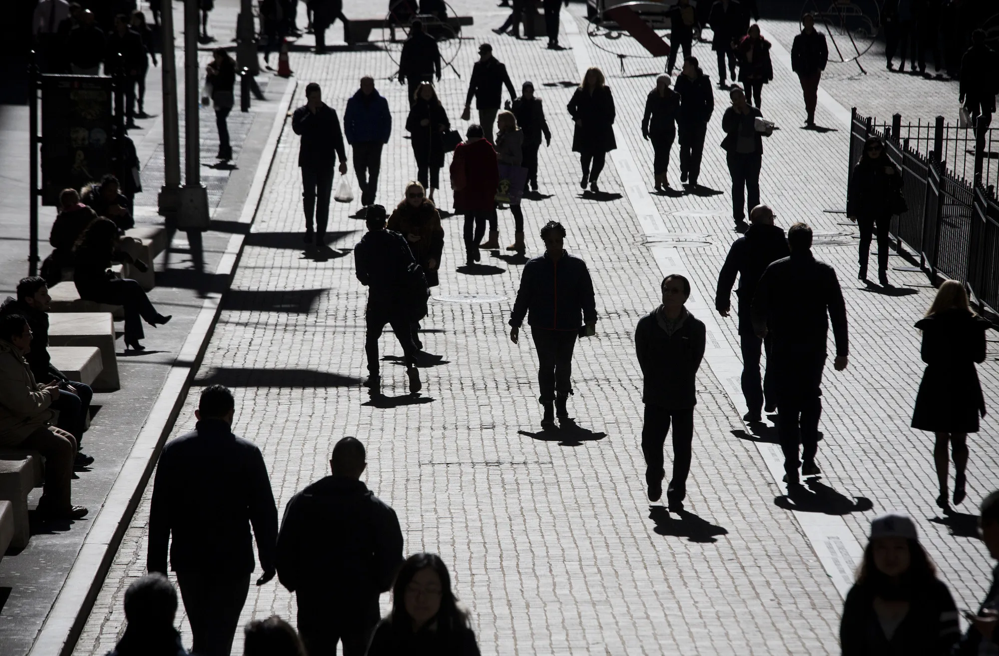 Pedestrians walk past the New York Stock Exchange.