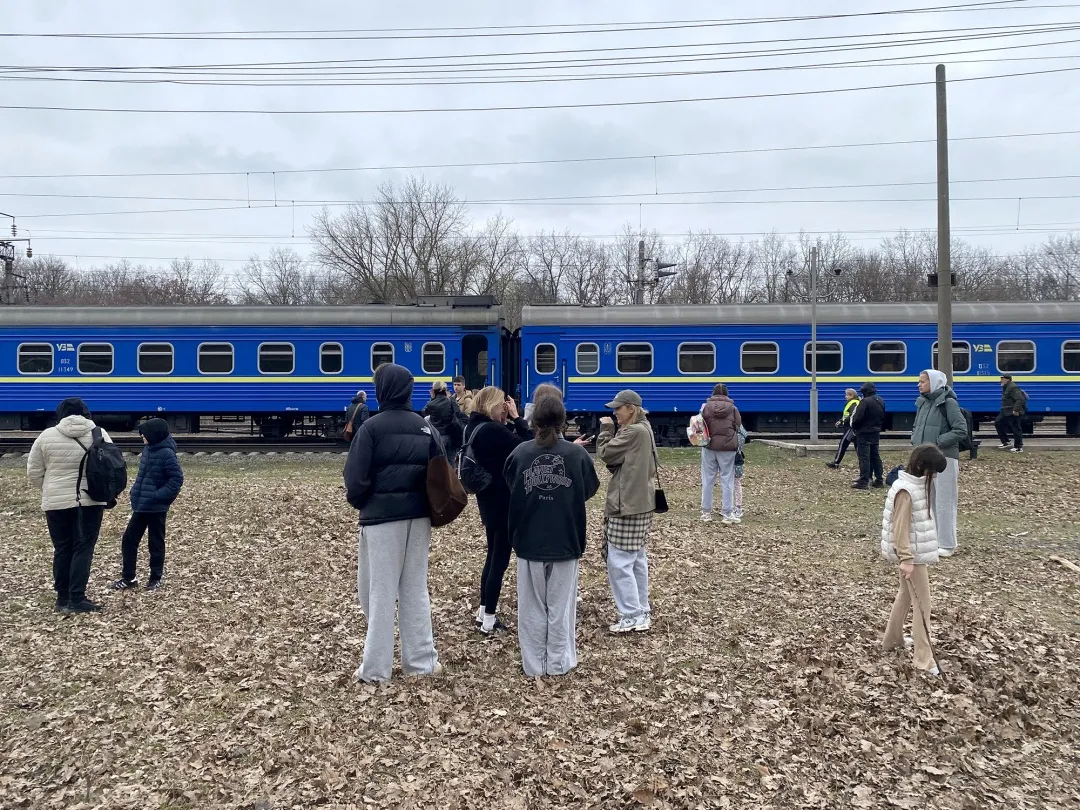 Passengers wait outside their sleeper train during an air alert of Russian drones at an undisclosed location in Ukraine on March 29.