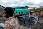 A member of the Afar Special Forces next to a damaged house in the village of Bisober in Ethiopia's Tigray region.&nbsp;