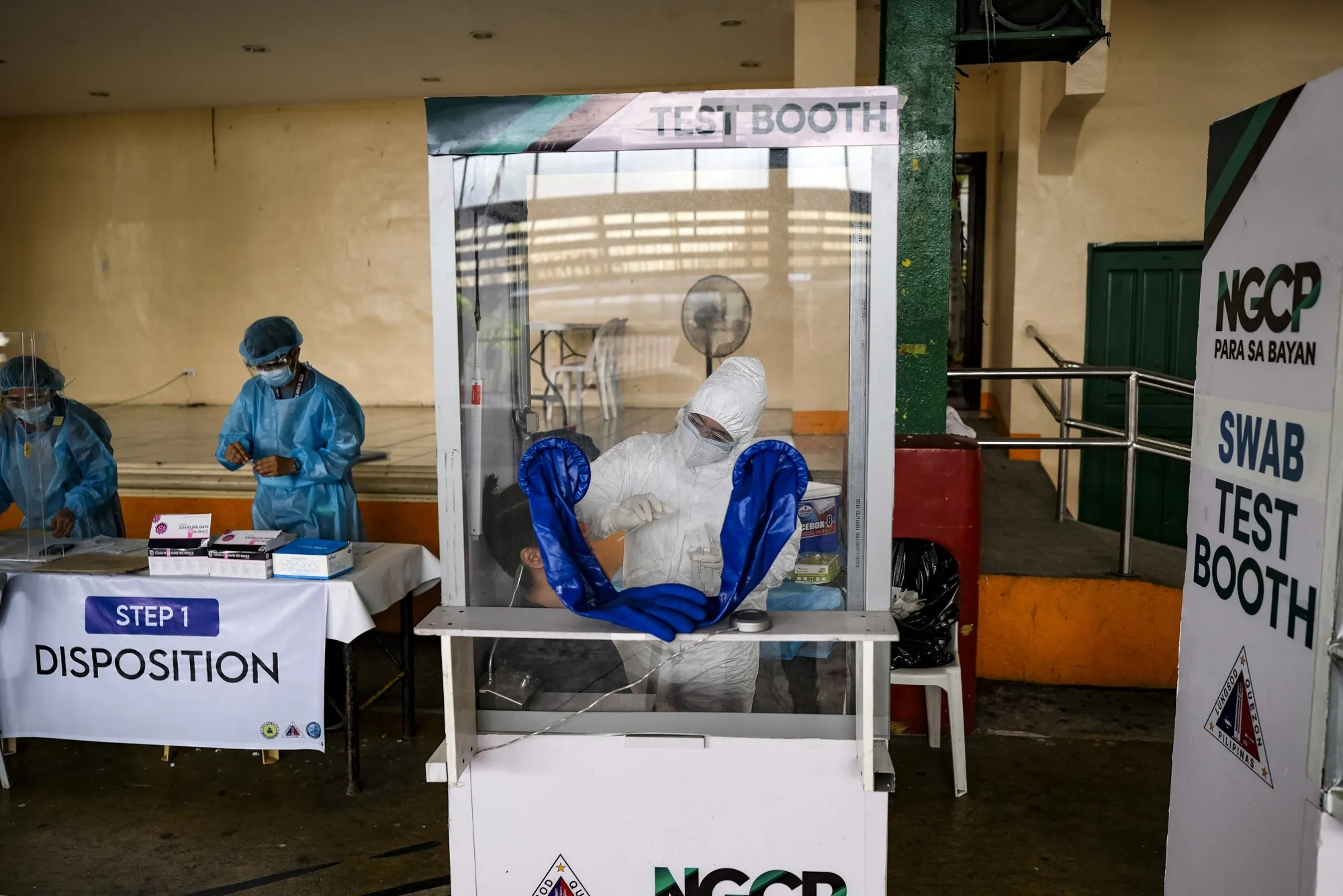 A medical worker conducts swab tests at a Covid-19 testing site in Quezon City, Metro Manila.