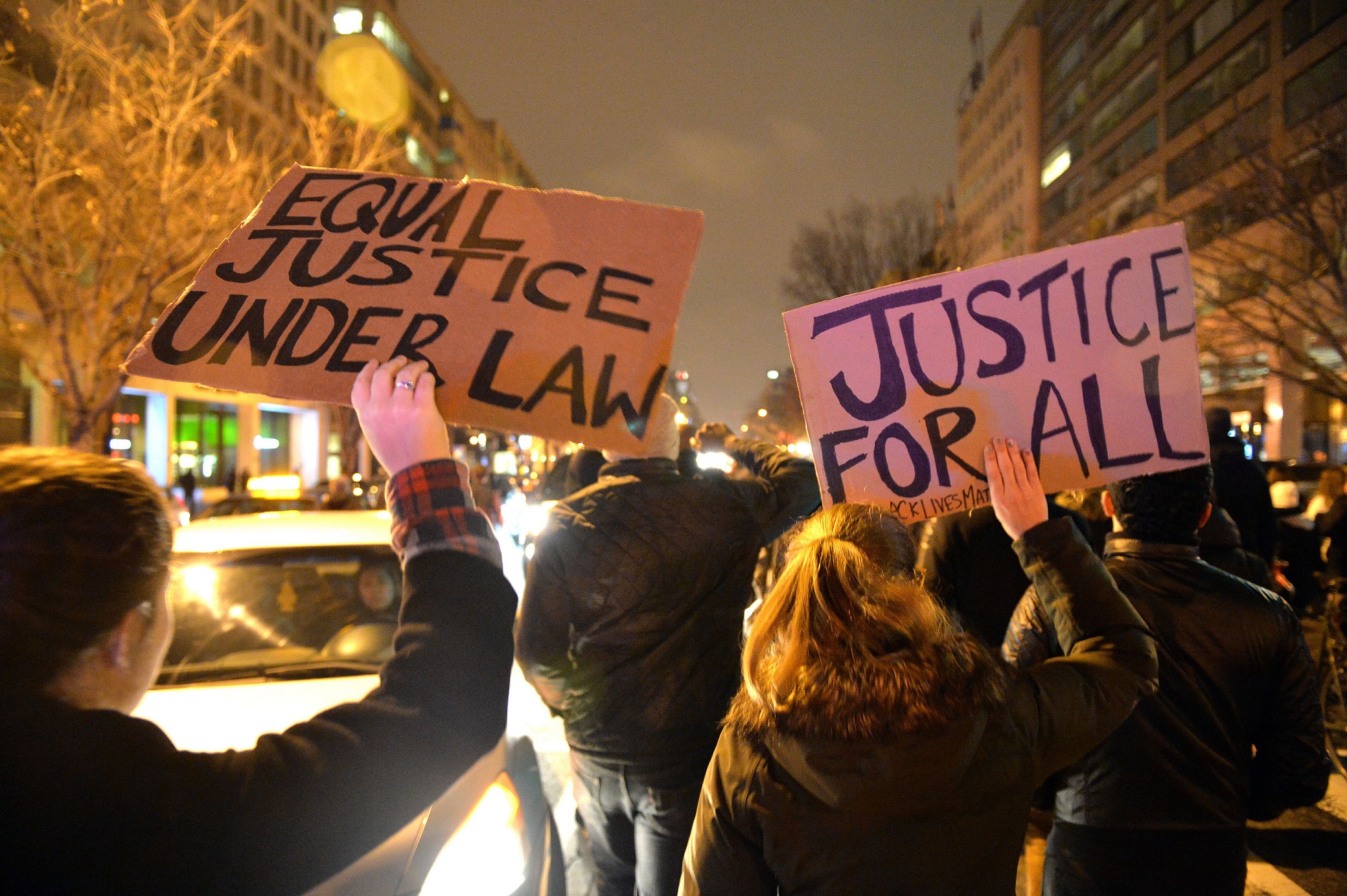 Protesters march holding banners in downtown Washington DC on December 05, 2014 during the third night of nationwide protests, after a grand jury decided not to charge a white police officer in the choking death of Eric Garner, a black man, days after a similar decision sparked renewed unrest in Missouri. Eric Garner died after being placed in a chokehold by New York police Officer Daniel Pantaleo while being arrested on suspicion of selling untaxed cigarettes in Staten Island
