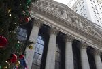 A Christmas tree stands near the New York Stock Exchange in New York, U.S., on Friday, Dec. 31, 2010. U.S. stocks swung between gains and losses, with the Standard & Poor's 500 Index heading for its second straight annual advance and its best December since 1991.