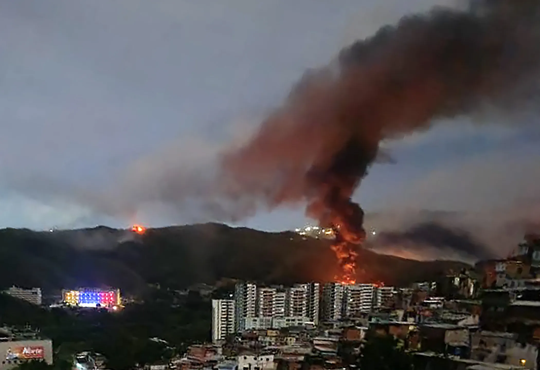 Fire at Fuerte Tiuna, Venezuela’s largest military complex, seen from a distance after a series of explosions in Caracas on Jan. 3. The US military launched a surprise attack on the country,&nbsp;capturing President Nicolas Maduro.