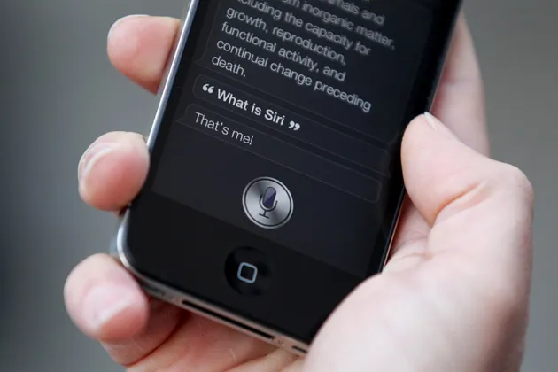A man uses 'Siri' on the new iPhone 4S after being one of the first customers in the Apple store in Covent Garden