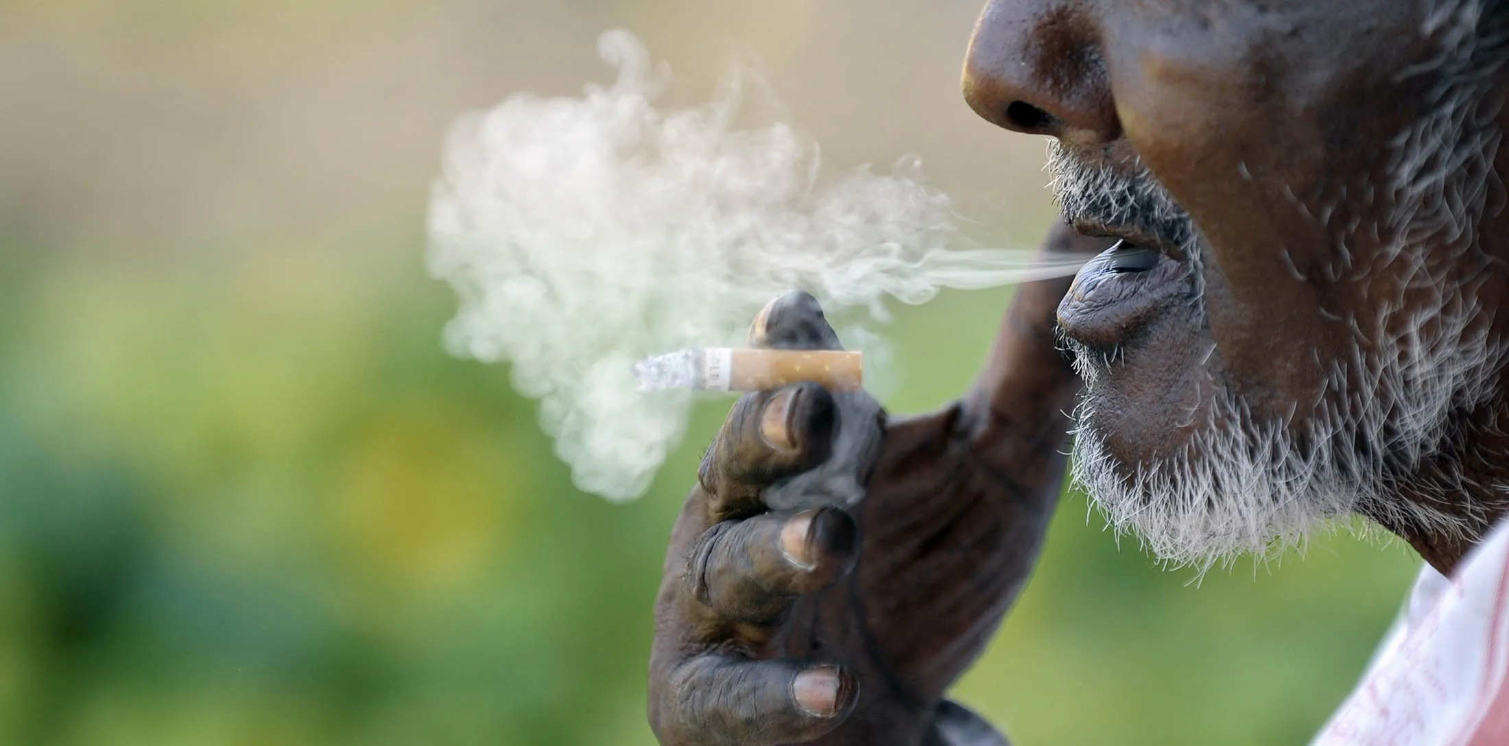 An Indian labourer smokes a cigarette as he takes a break at the Gaddiannaram fruit market in Hyderabad on February 28, 2013. India's government on Thursday earmarked $1.9 billion for a populist programme to combat malnutrition, a move seen as a major vote winner for the ruling Congress party in elections next year. AFP PHOTO / Noah SEELAM (Photo credit should read NOAH SEELAM/AFP/Getty Images)
