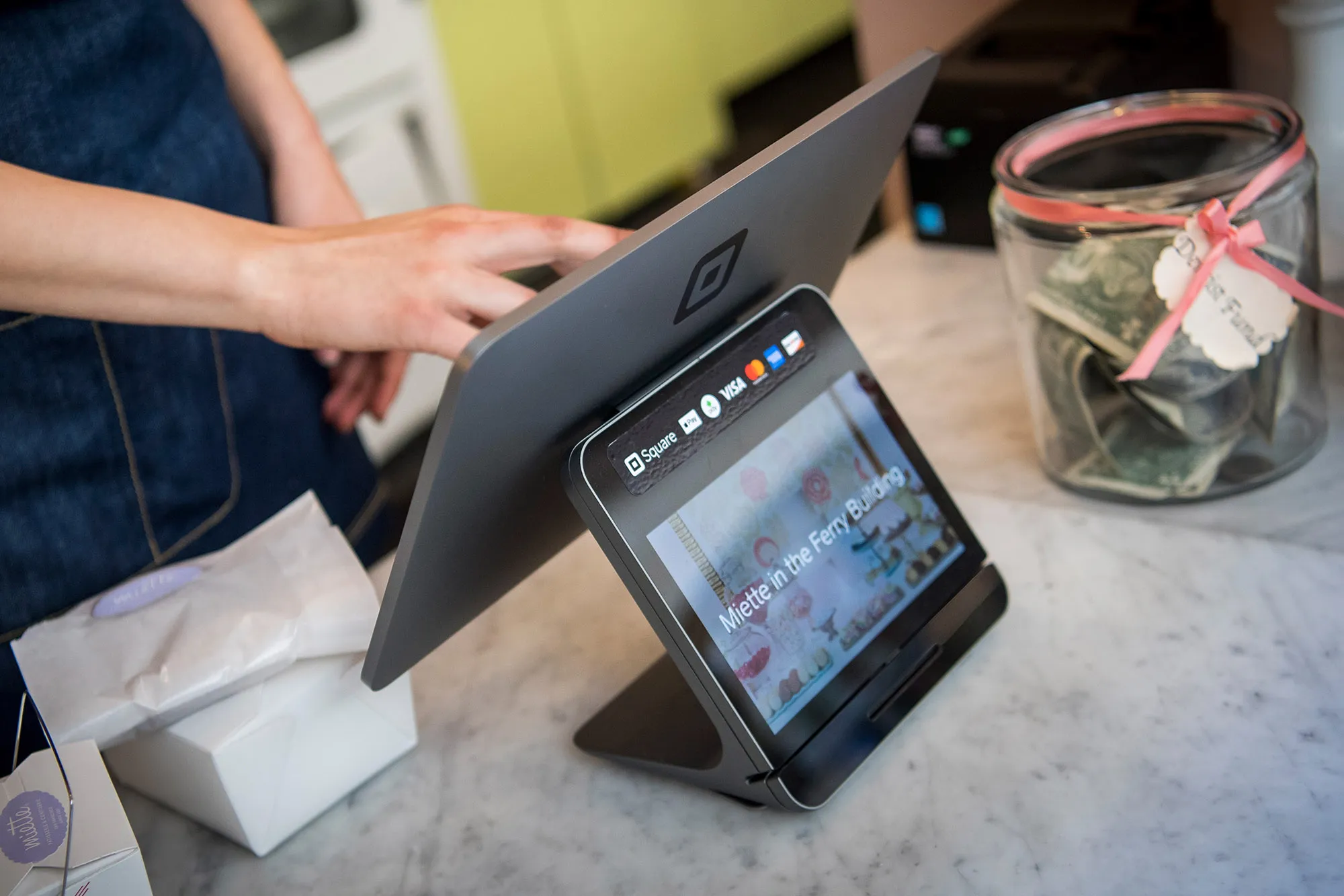 A merchant uses a Square Inc. payment device in San Francisco.