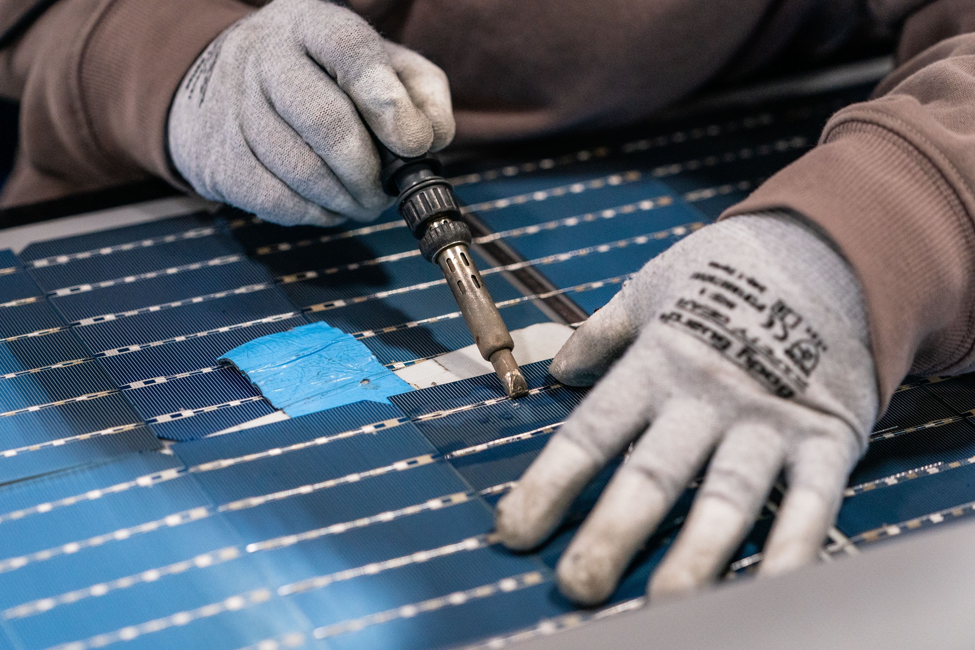 An employee solders solar panel cells at Hanwha’s facility in Dalton, Georgia.