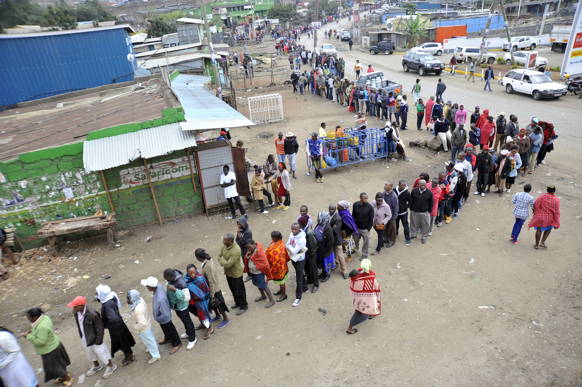 Voters queue along a street outside a polling station on Aug. 8, 2017.
