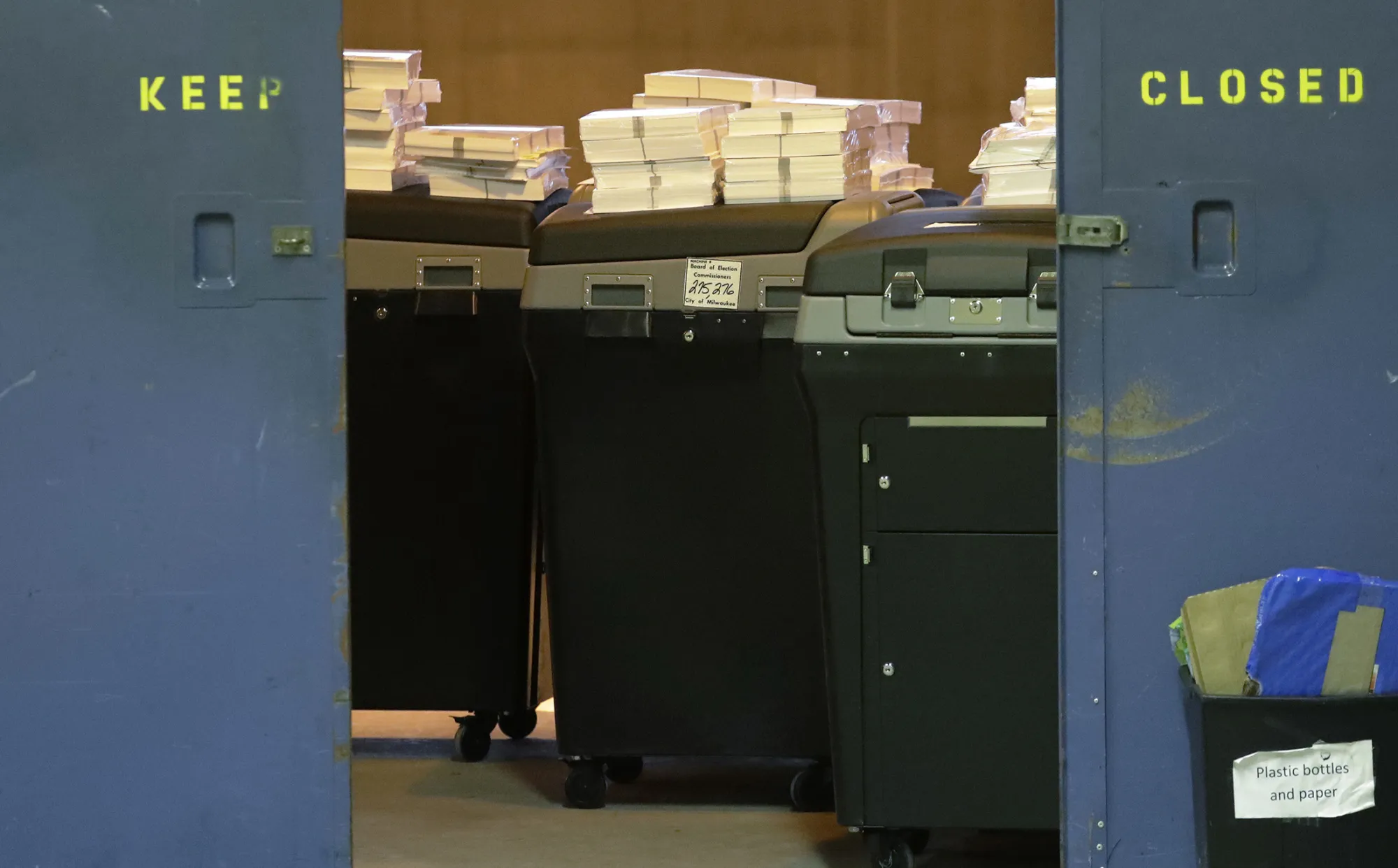 Ballots are stacked up behind a door as a statewide presidential election recount begins in Milwaukee, on Dec. 1, 2016.
