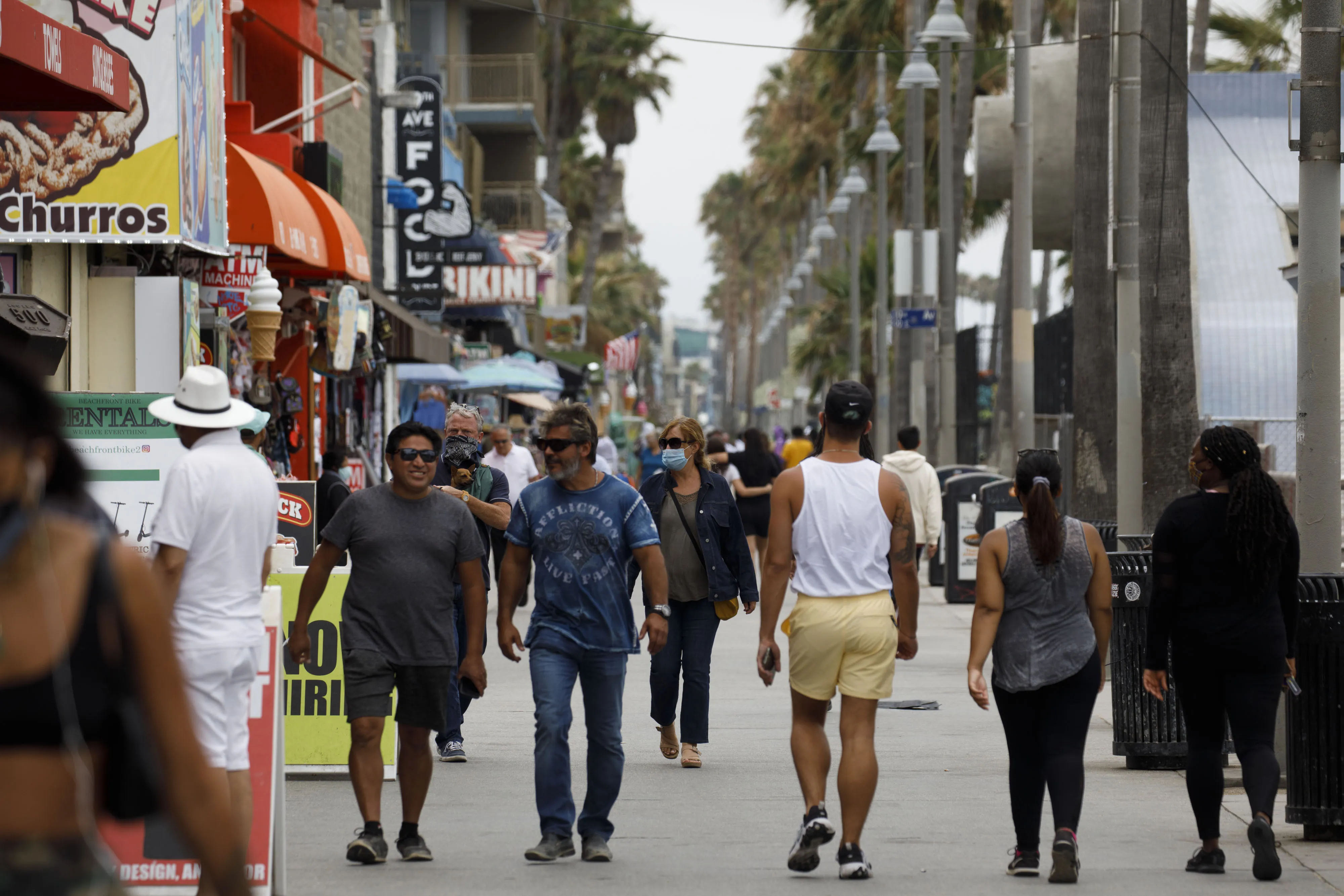 Pedestrians walk through Venice Beach in Los Angeles on Friday.