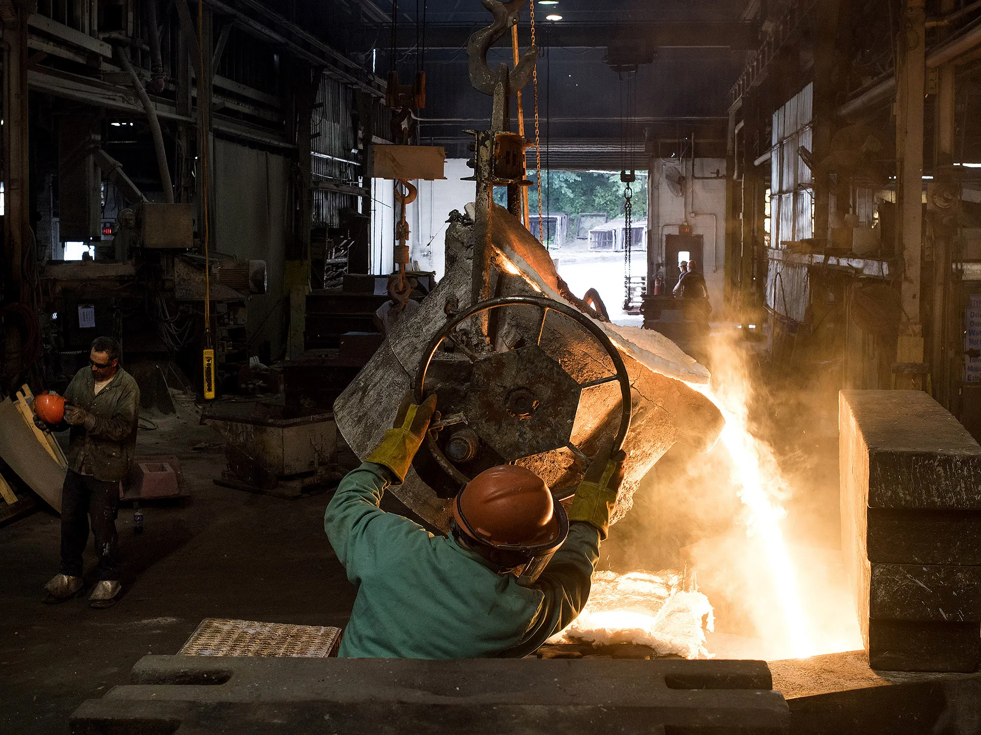 Molten steel is poured from a ladle into a large mold at a castings facility in Salem, Ohio.