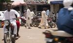 Pedestrians pass a mobile phone store in N'Djamena, Chad