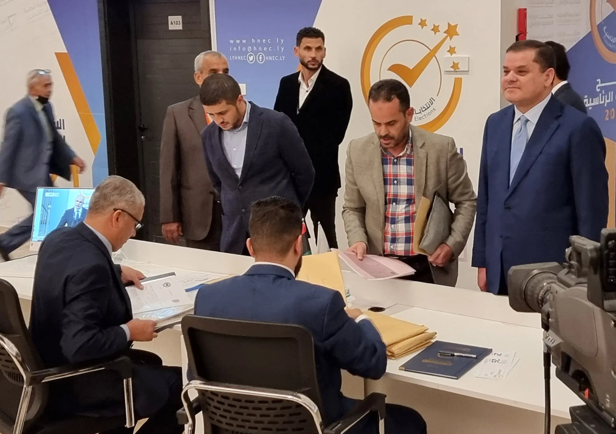 Libya's interim Prime Minister Abdul Hamid Dbeibah, right,&nbsp;registers his candidacy for the presidential election in the capital Tripoli, on Nov,&nbsp;21.