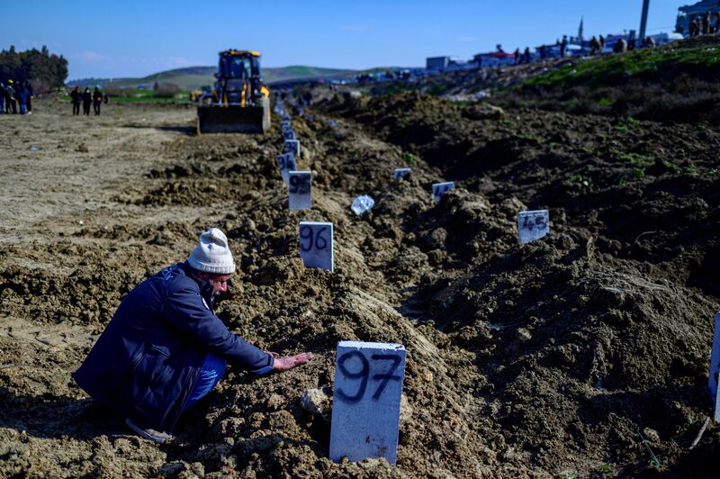 A man mourns at a mass grave area in Hatay, on Feb. 10.