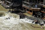 CORRECTS TOWN - Flood waters sweep through the ancient town of Feng Huang in central China's Hunan province, Saturday, June 4, 2022. State media reported some deaths and missing in flooding in the province. (AP Photo)