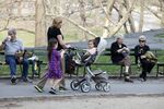 A woman pushes a baby stroller through Central Park in New York on April 10, 2013
