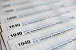 U.S. Department of the Treasury Internal Revenue Service (IRS) 1040 Individual Income Tax forms for the 2014 tax year are arranged for a photograph in Tiskilwa, Illinois, U.S., on Monday, March 16, 2015.
