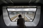 A woman stands on a SkyTrain car its way to the airport in Vancouver, British Columbia.