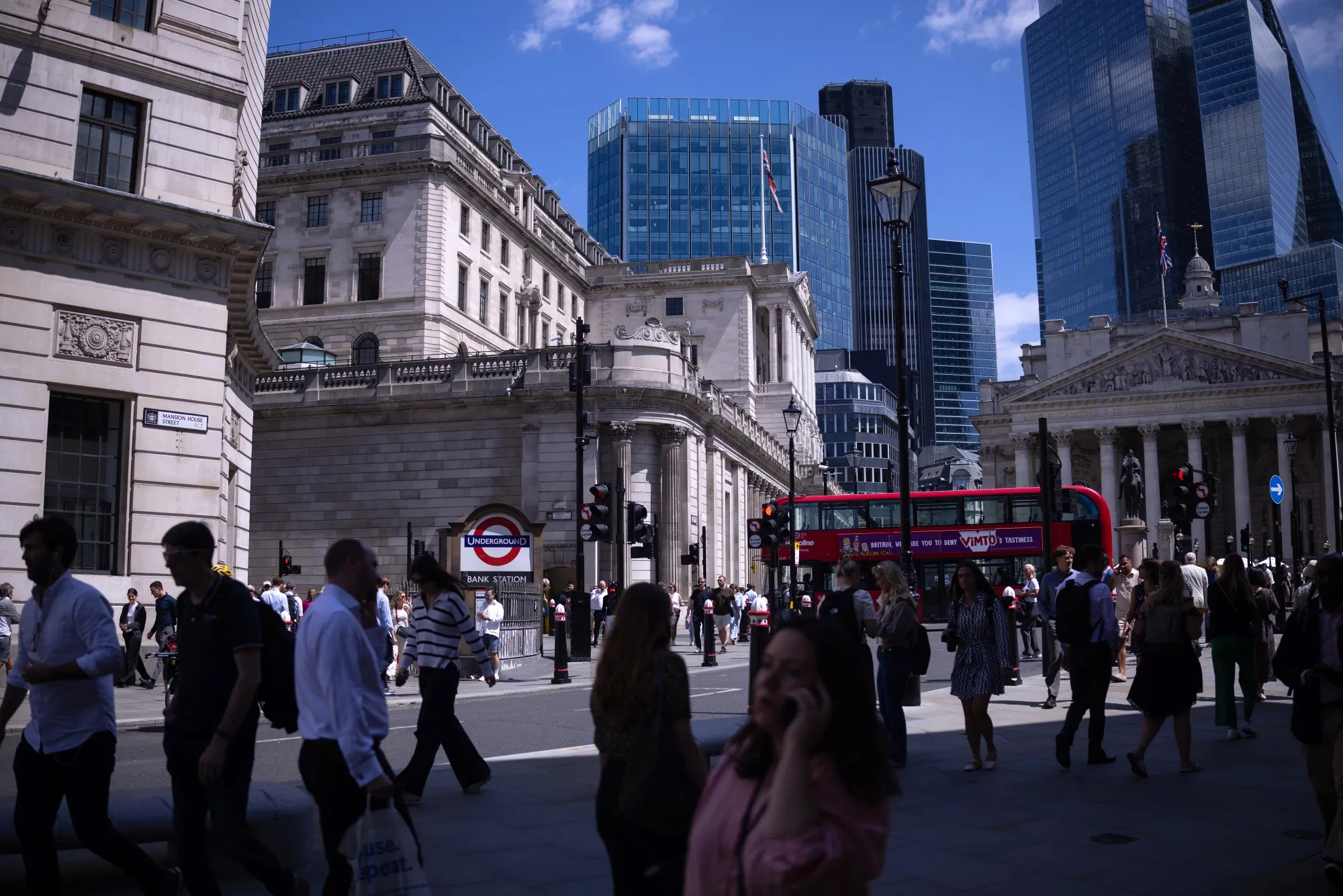 City workers pass the Bank of England in London.