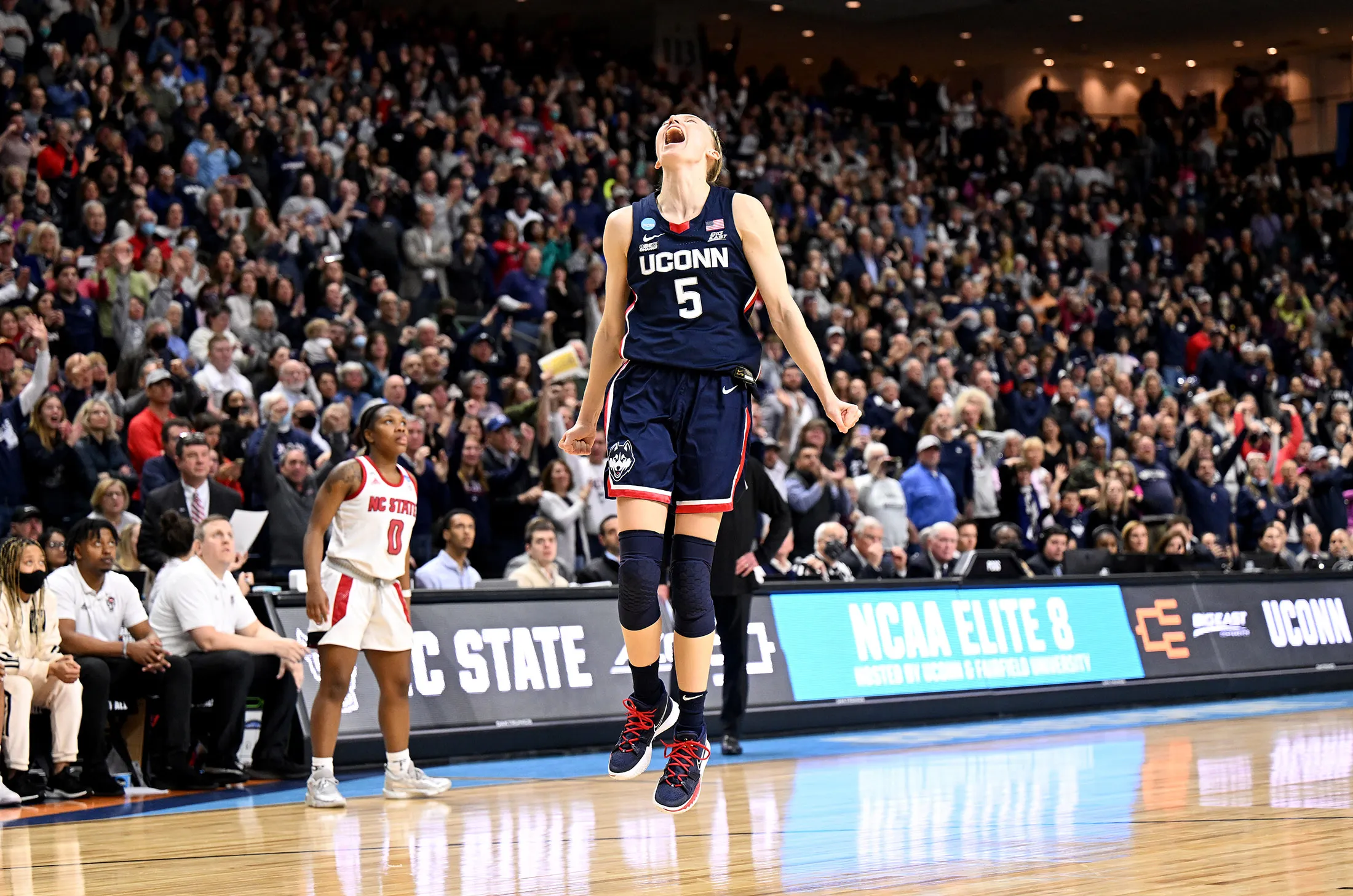 Paige Bueckers of the Connecticut Huskies celebrates after a victory against the NC State Wolfpack during the Elite Eight round of the 2022 NCAA Tournament&nbsp;on March 28.