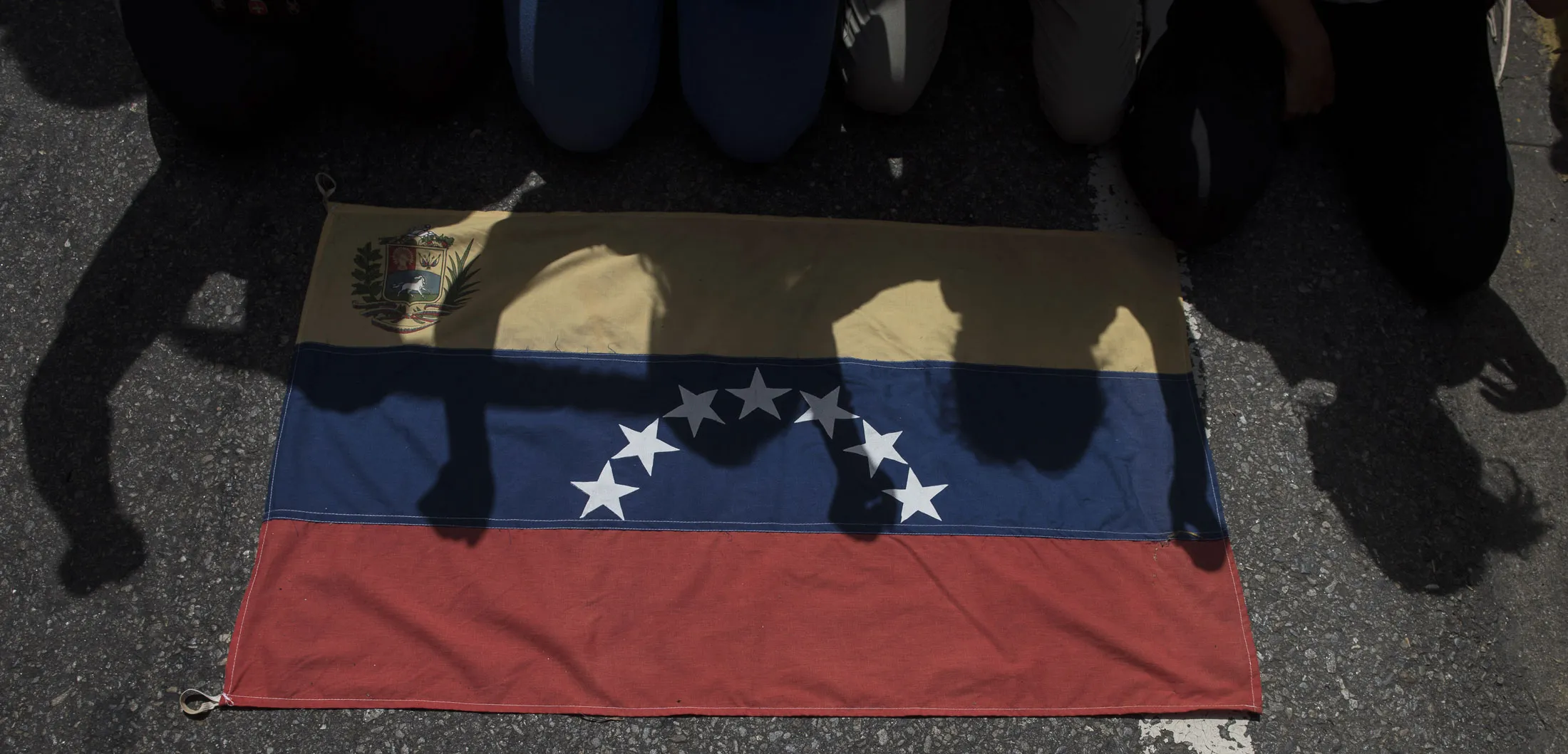 The shadows of demonstrators are cast on a Venezuelan flag during an anti-government protest in Caracas on April 4.
