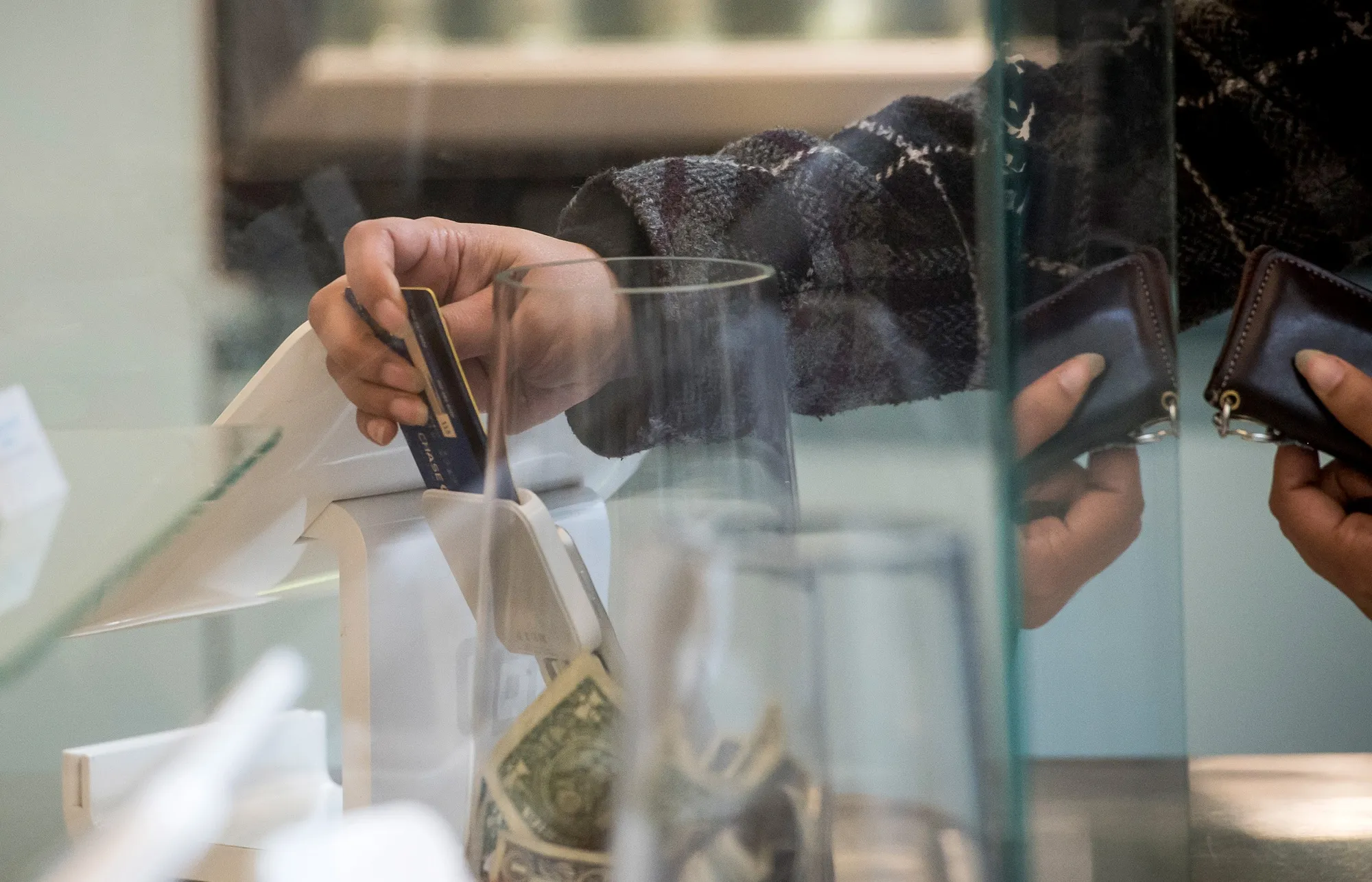 A customer inserts a credit card into Square Inc. device while making a payment in San Francisco, California.